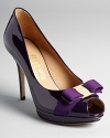 Subtly textured purple patent leather adds sensual allure to Salvatore Ferragamo's peep toe platform pumps.