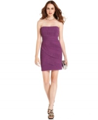 The bandage dress gets revamped by BCBGMAXAZRIA. Tiers of fitted, textured fabric form a curve-flattering strapless sheath with a neckline that's perfect for showing off a to-die-for statement necklace.