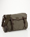 Authentic leather accents make this versatile canvas messenger bag a suitable carryall for work or weekend.