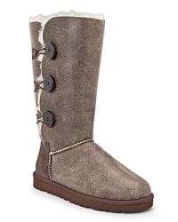 Three pert buttons march up the sides of these soft, shearling-lined boots from UGG® Australia.