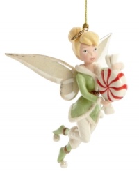 Tinker Bell delivers a sweet treat to your tree – a pixie-sized peppermint! – in this enchanting Disney ornament, featuring gold-dusted porcelain by Lenox.