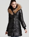 A luxe fur trim lends enviable style to this cozy down puffer coat from Mackage.