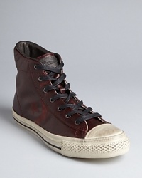 Inspired by vintage sneaker designs, John Varvatos and Converse partner in a unique and powerful collaboration that results in this striking high top, perfect for your nights out or when your casual look needs a heavy dose of cool. Check out the effaced leather logo treatment on the side for that extra bit of flair.