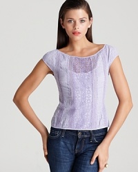 A soft purple Nanette Lepore top features a gingham print and lace inset for country chic that pairs with the season's must-have floral trend for unexpected femininity.