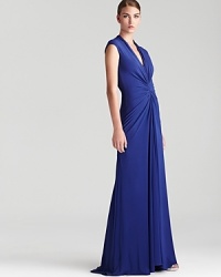 Sleek and stunning, this floor-skimming Nicole Miller dress exudes grace with ruched details and an alluring back slit.