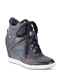 GUESS takes the sporty sneaker to new heights with a dramatic hidden wedge and tapered almond toes.