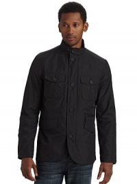 A stylish way to conquer the elements, this waterproof design keeps you dry and comfortable with roomy exterior pockets for increased functionality.Stand collar Front zipper with button storm flap Long sleeves with button cuffs Dual button flap pockets One zip pocket Dual flap pockets Two inside zip pockets Partially lined About 27½ from shoulder to hem Polyester Hand wash Imported