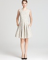 Winter white tweed lends a fresh, ladylike look to Shoshanna's fit-and-flare dress, rendered with a playful pleated skirt.