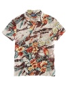 A preppy island print lends bold tropical appeal to a classic-fitting short-sleeved polo shirt in fluid cotton jersey.