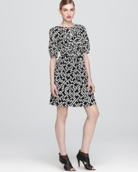 Ladylike with an edge, this Trina Turk dress of stretch silk flaunts a graphic print and wispy faux-patent belt.