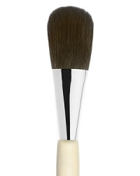 An oversized brush to apply face powder made of luxuriously soft black squirrel hair.