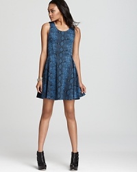 A slithering snake print adorns a youthful skater silhouette on Aqua's ponte knit, everyday-wear dress.