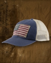 A baseball hat with cotton and mesh panels for breathability gets a vintage feel from a distressed flag patch at the front.