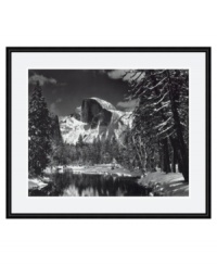 An awe-inspiring view from the master of landscape photography, Ansel Adams. Taken from the original Sentinel Bridge in Yosemite Valley, this black and white print demonstrates the power and majestic beauty of Half Dome. In a rounded black frame.