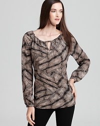 An intricate snakeskin print breathes distinctive life into a breezy Anne Klein blouse for a stylish walk on the wild side.