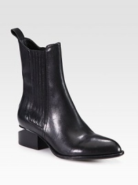 Fully commit from tip to toe in this architectural leather boot with a metal inverted heel and comfortable elastic panels. Stacked heel with metal notch, 1¾ (45mm)Shaft, 7Leg circumference, 10Leather upper with elastic stretch panelsPull-on styleLeather lining and solePadded insoleImported