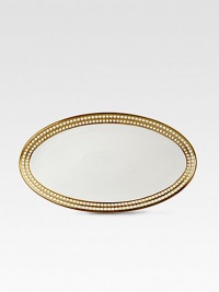 A beautiful serving platter in fine Limoges porcelain, made entirely by hand and finished with individually-applied 14k gold along the pearl border. From the Perlee Gold Collection Porcelain 14 X 7 Dishwasher safe Imported 