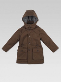 Crafted in plush cotton, this waterproof, flannel-lined, hooded parka has a full-zip front with buttoned covering