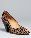 Bettye Muller gives these pumps retro appeal with '60s style stacked wooden heels and a swinging leopard print: Groovy.