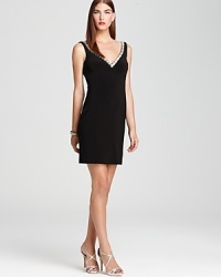 A deep double v neck is detailed in sparkling rhinestones on this timelessly elegant Basix dress.