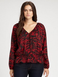 Pull on this printed blouse featuring a decolletage-complementing neckline. Its comfortable cinched waist ensures a feminine silhouette.V-necklineLong sleevesElasticized cuffsAllover printElasticized waistAbout 24 from shoulder to hemPolyesterMachine washImported