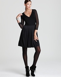 Sheer accents and a mixed-media silhouette lend contemporary edge to a classic DKNY dress--extra chic when styled with black tights.