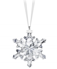 Swarovski makes winter magic with the 2012 annual snowflake ornament. Delicate cut crystal creates a flurry of sparkle and shine on your tree or hanging in a window. With dated metal charm.