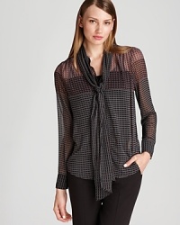 With a sheer silhouette and delicate neck tie, this Bloomingdale's exclusive Gerard Darel blouse embraces a romantic sense of style with a grand flourish.