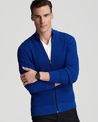 A handsome zip-front sweater, crafted in soft cotton, demonstrates its utility all week, pairing effortlessly with jeans and chinos for a sporty but refined style.