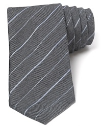 The modern skinny width of this handsome tie complements the classic stripe pattern for a fine accent to your wardrobe.