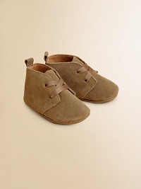 Adorable baby booties crafted in ultra-plush suede in a lace-up silhouette.Ribbon tieSuede upperLeather liningLeather solePadded insoleImported