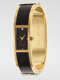 A chic enamel accented goldtone bangle timepiece. Quartz movementWater resistant to 3 ATMRectangular goldtone case, 16mm (0.6)Smooth bezelBlack dialDot hour markersSecond hand Enamel accented goldtone bangleImported