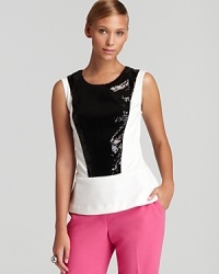 A study in contrasts, this Calvin Klein tank goes bold in black and white, pairing a sleek sequin bodice with a structured peplum hem for serious modern edge.