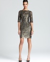 In shimmering metallic lace, Shoshanna's silk dress lends a sparkling, modern look for the season.