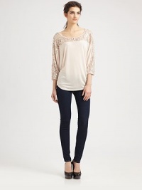 Metallic lace trim outlines this lengthy dolman top of ultra-soft modal. Wide roundneckButton frontDropped shouldersThree-quarter dolman sleevesBack contour hemMicro modalDry cleanMade in USAModel shown is 5'10 (177cm) wearing US size Small.