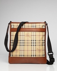 Tall, plaid and useful, this crossbody messenger bag features Burberry's signature plaid embellished with brown leather trim and a black crossbody strap.