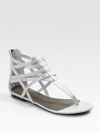 A strappy structure made of metallic leather has an electric effect on the ensemble.Back zipper Leather lining and sole Padded insole Imported