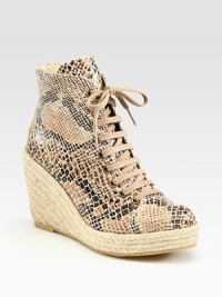 Classic ankle-grazing silhouette modernized by a snake-print faux leather upper, lace-up front and an espadrille wedge. Braided hemp wedge, 4 (100mm)Braided hemp platform, 1 (25mm)Compares to a 3 heel (75mm)Snake-print faux leather and burlap upperFaux leather liningRubber solePadded insoleMade in SpainOUR FIT MODEL RECOMMENDS ordering true whole size; ½ sizes should order the next whole size up. 