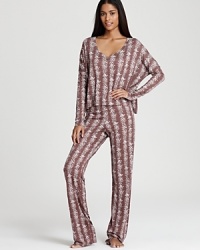 A floral-stripe print and trendy dolman sleeves give this 40 Winks pajama set seasonal style.