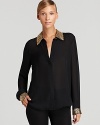 A careerist essential goes rocker chic as gold-tone studs jazz up the cuffs and collar of a classic VINCE CAMUTO blouse.