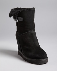 A plush faux shearling lining lends comfort to Ash's wedged Youri boots.