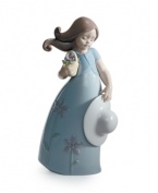 Little Violet wears a flower-print dress to match her basket of blooms in this darling collectible, handcrafted in Lladro porcelain.