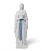 A soothing presence, Our Lady of Lourdes is draped in layers of beautiful white with a sash of blue about her waist, all in handcrafted Lladro porcelain.