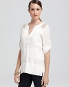 Lace details on this BCBGMAXAZRIA tunic make this piece drop-dead gorgeous.