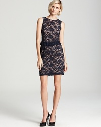 A subtle peplum feels delicately feminine on this sleeveless Aidan Mattox dress, rendered in dark-hued lace.