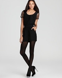 BCBGeneration's scoop neck romper defines elegant ease this season with sheer embellished sleeves and a chicly-cinched waist--tights and a well-heeled pump complete this runway-worthy ensemble.