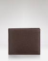 Carry your everyday essentials in a distinct pebbled leather wallet from Longchamp for a touch of modern luxury.