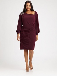 This sleek and sultry dress with a hint of stretch was made for your curves. Its alluring asymmetrical neckline is flawlessly complemented by a sparkling shoulder embellishment.Asymmetrical necklineBlouson sleevesBanded cuffsShoulder embellishmentConcealed back zipperFully linedAbout 25 from natural waist95% polyester/5% spandexDry cleanMade in USA of imported fabric