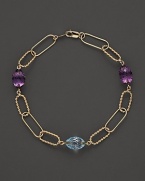 Faceted oval amethyst and blue topaz add rich sparkle to links of 14K yellow gold. By Nancy B.