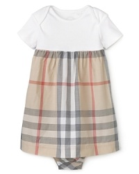 A youthful empire waist silhouette makes this Burberry dress a classic choice for dressing the most stylish little girls.